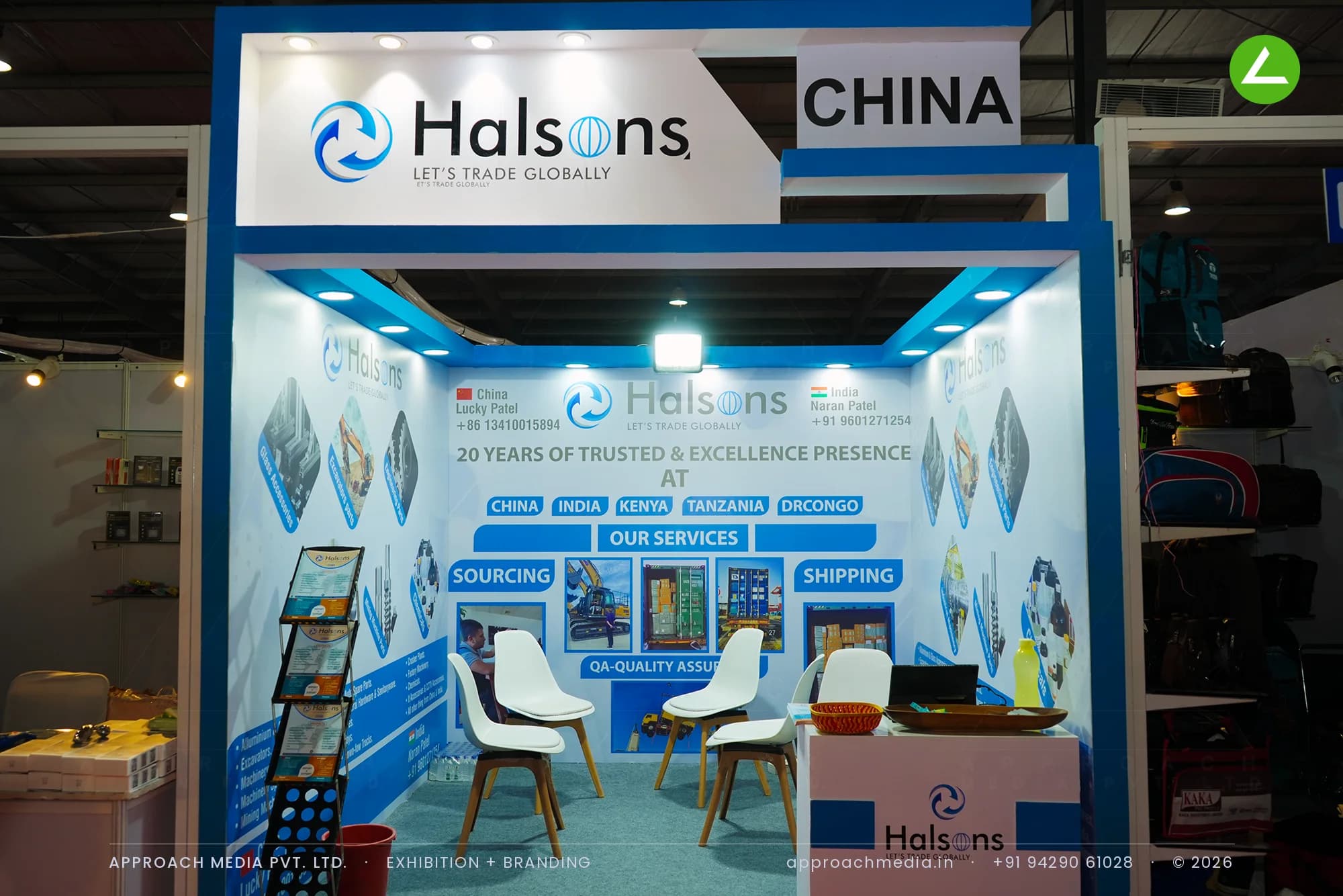 Halsons exhibition stall design at GPBS Gandhinagar with blue-bordered printed sourcing and shipping graphics on white walls