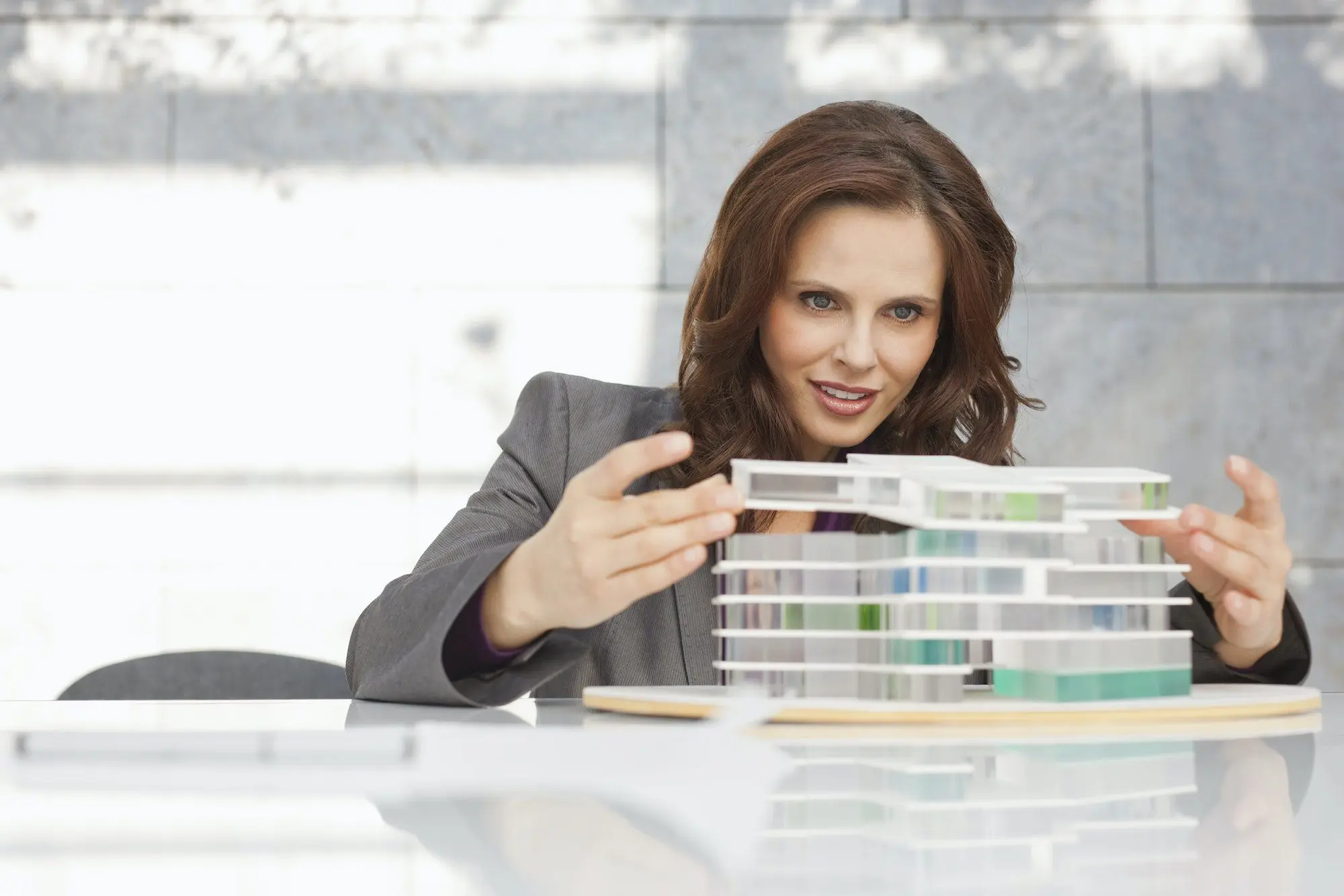 Germany, Leipzig, Businesswoman looking at architectural model